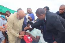 The Vice President in Zanzibar, Honourable Hemed S Abdalla giving polio drops to a child during the launch event