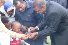 The Vice President in Zanzibar, Honourable Hemed S Abdalla marking a vaccinated child during the launch in Zanzibar