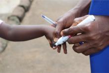 A child being finger marked after receiving malaria drug in Adamawa state.