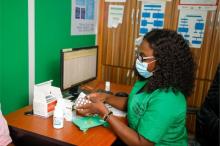 A pharmacist dispensing drugs to a patient