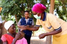 A health worker giving polio drops