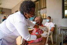 An elderly man at the health facility reciving his first dose of COVID-19 vaccine.jpg