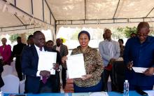 Hon. Ummy Mwalimu and Dr. Zabulon Yoti displaying the hand-over certificates