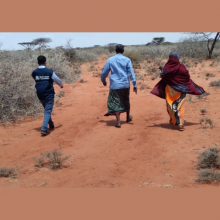 WHO Surveillance Officer Abdisalan Muktar Ali walking with villagers the last 4 km to reach Mohammed, the child with suspected AFP case investigation, Verification and sample collection  