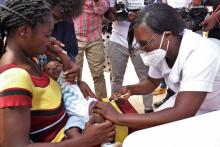 A nurse administering a malaria vaccine to a child to mark the beginning of the expanded immunization programme