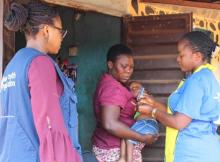 Vaccinator finger-marking a vaccinated child