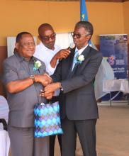 WHO Representative, Dr Sagoe-Moses presenting a souvenirs as part of WHO 75th anniversary to the Minister of Health and Social Services.  