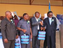 WHO Representative, Dr Sagoe-Moses presenting a souvenirs as part of WHO 75th anniversary to the Minister of Health and Social Services, Hon. Hendrick Gaobaeb, Constituency Councilor and Kunene Regional Chairperson and Mr Shapumba, Health Director of Kunene Region. 