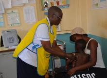 Little Wesley is comforted by a nurse and his mum after he received his final malaria vaccine at Homa Bay County Hospital