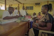 Mrs Armstrong and her son Joel at the registeration desk at the immunization centre