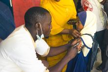 Child being vaccinated at a school site