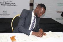 Assistant Minister of Health, Mr Lawrence Ookeditse, signing the commitment for the implementation of the One Health National Strategy