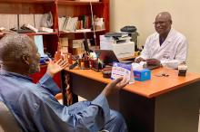 Professor Papa Ahmed Fall speaking to a client