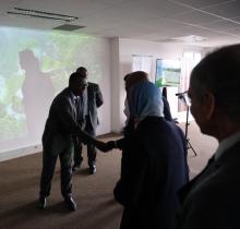 Delegates greet each other at an indoor event venue