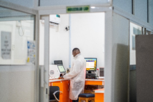A health worker working on a TB sample in a laboratory.png