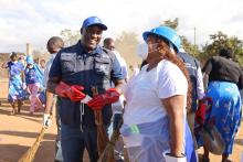 WHO Malawi Representative Dr Charles Njuguna and Minister of Health Hon Madalitso Baloyi lead the sweeping exercise ant Phwetekere market in Lilongwe