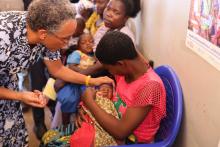 Unicef Rep Penelope Campbell vaccinates a child