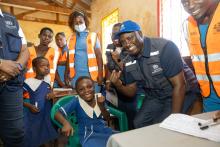 WHO Malawi Rep Dr Charles Njuguna poses with a child after administering the vaccine