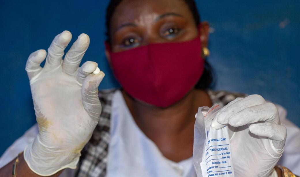 Nurse Theresa Jugu Stephen OIC  administering medication to  asymptomatic patient on HBC