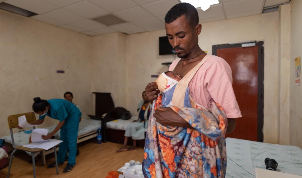 Solomon Minayehu provides skin-to-skin care to one of his preterm twins at Felege Hiwot Hospital.