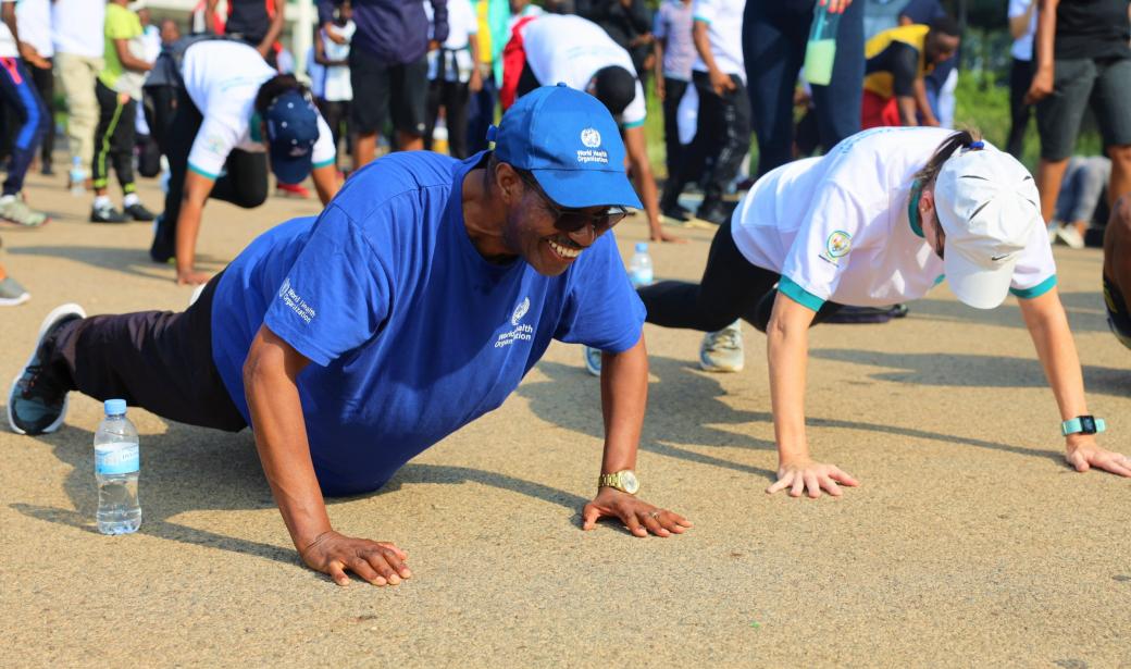 People on the ground doing push-ups.