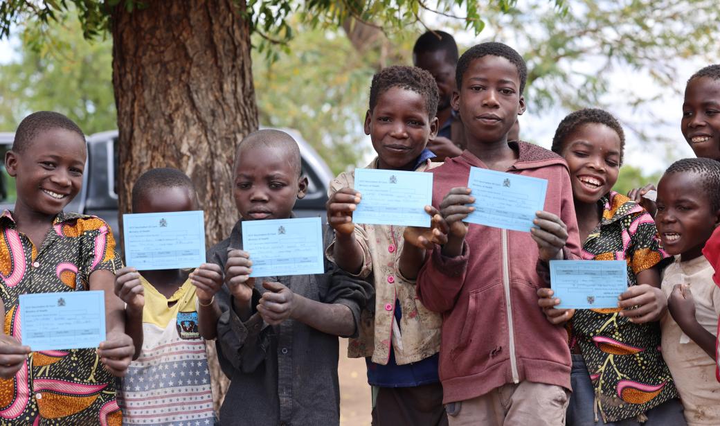 Children displaying their vaccination cards
