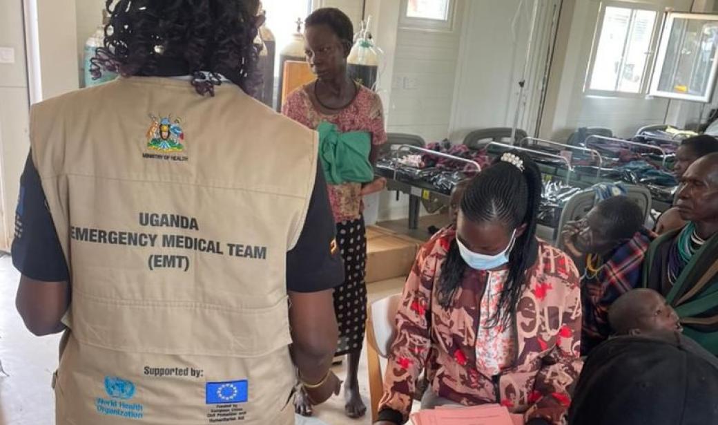 An EMT member talks to mothers at the Measles Treatment Unit in Moroto