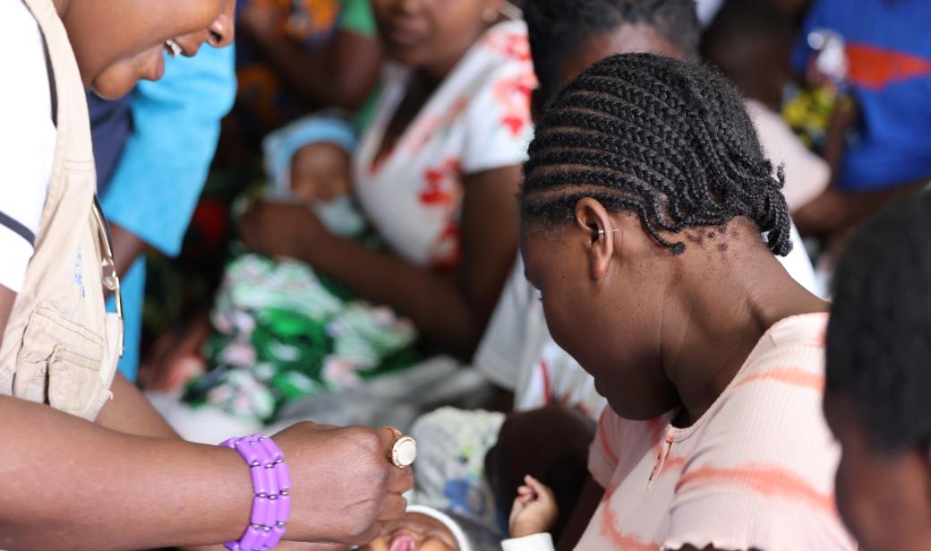Health Minister, Hon Khumbize Kandodo Chiponda vaccinates a child during the event